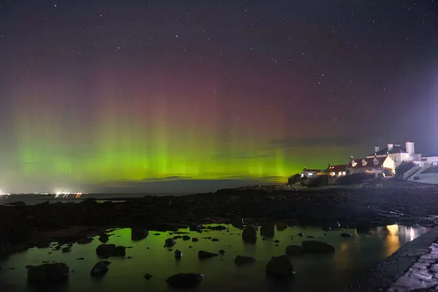 The aurora borealis, better known as the northern lights appear early morning over St Mary's Island in Whitley Bay on North Tyneside on Monday, October 3, 2022. (Photo by Owen Humphreys/PA Images via Getty Images)