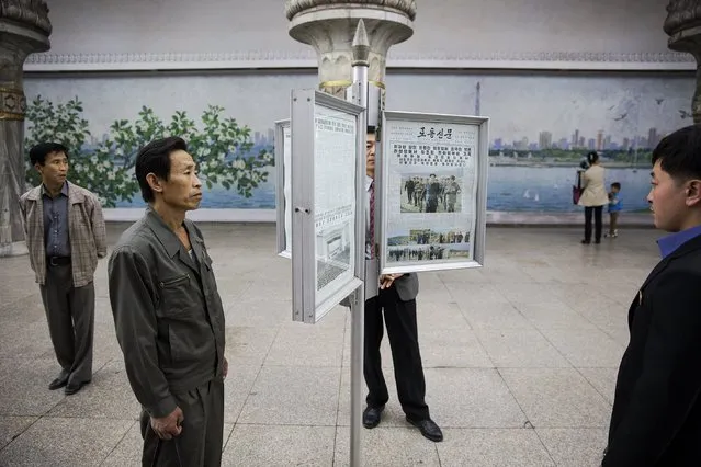 People read newspapers displayed inside a subway station visited by foreign reporters during a government organised tour in Pyongyang, North Korea October 9, 2015. One of the world's most inaccessible places, North Korea has invited foreign journalists to Pyongyang this week for celebrations marking the 70th anniversary of its ruling Workers' Party scheduled for October 10. (Photo by Damir Sagolj/Reuters)