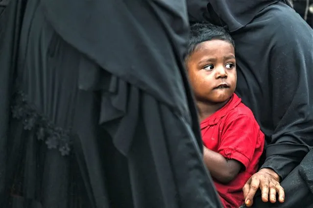 A Rohingya refugee child rests upon his arrival by a boat in Lamnga beach, Aceh province on January 8, 2023. A wooden boat carrying nearly 200 Rohingya refugees, a majority of them women and children, landed on Indonesia's western coast on January 8, police said. (Photo by Chaideer Mahyuddin/AFP Photo)