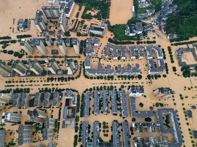 A drone view shows buildings and roads are half submerged in floodwaters after heavy rainfalls, in Rongjiang county, Guizhou province, China on June 24, 2025. (Photo by China Daily via Reuters)