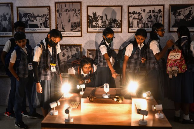 School students look at pictures of Mohandas Karamchand Gandhi on the occasion of Martyr's Day, marking his 75th death anniversary at Egmore Museum in Chennai, India 30 January 2023. Martyr's Day is observed annually on 30 January in India to commemorate the death of the father of the nation, Mahatma Gandhi, who was assassinated by Nathuram Vinayak Godse on 30 January 1948. The day is observed as a day of peace and non-violence. (Photo by Idrees Mohammed/EPA/EFE)