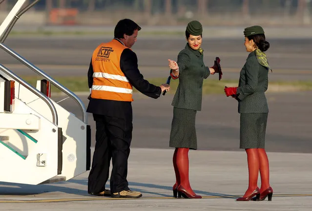 A security staff member checks an Alitalia hostess before Pope Francis' leaving for his pastoral trip to Georgia and Azerbaijan at the Leonardo da Vinci-Fiumicino Airport in Rome, Italy September 30, 2016. (Photo by Remo Casilli/Reuters)