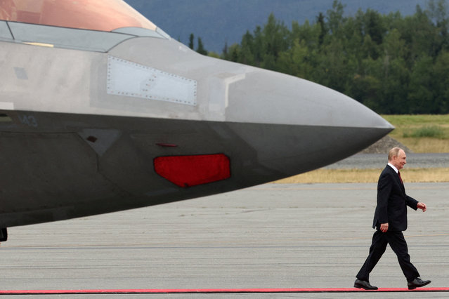 Russian President Vladimir Putin walks towards President Donald Trump at Joint Base Elmendorf-Richardson, in Anchorage, Alaska, on August 15, 2025. (Photo by Kevin Lamarque/Reuters)