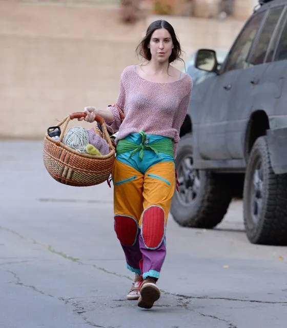 Bruce Willis' daughter Scout Willis puts on a colorful display as she returns home from her knitting class in Los Angeles on February 19, 2023. Scout carried a basket of yarn and wore a pink knit sweater, multi colored trousers, socks and sandals. (Photo by The Image Direct)