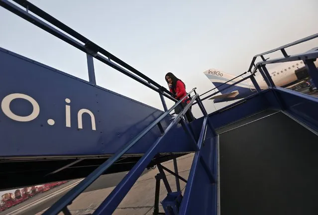 A passenger boards an Indigo Airlines' flight bound for Srinagar at an airport in New Delhi November 21, 2014. Picture taken November 21, 2014. (Photo by Adnan Abidi/Reuters)