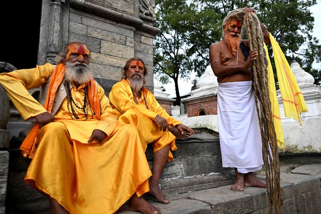 Sadhus or Hindu holy men rest at Pashupatinath temple complex in Kathmandu on August 27, 2025. Nepal's Supreme Court has ruled that naked Hindu holy men need not wear clothes to attend a revered temple, declaring that their age-old tradition of nudity is not obscenity. The ash-smeared and dreadlocked ascetics known as Naga sadhus – devotees of the Hindu deity Shiva who renounce their family and worldly possessions, including clothing – said on August 27 that they welcomed the top court decision. (Photo by Prakash Mathema/AFP Photo)