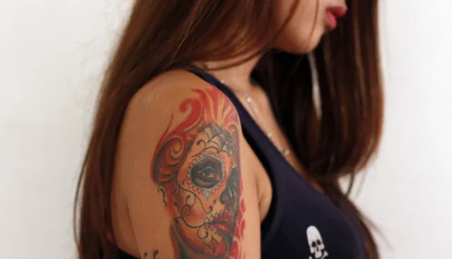 A tattoo is displayed on the arm of a girl during Bandung Body Art Festival at in Bandung, West Java, on December 7, 2014. Upon its establishment in 2010, founders of the Bandung Body Art Festival sought to celebrate an art form that was once taboo and associated with criminals. Tattoos are now an increasingly acceptable part of Indonesia’s urban landscape, and the annual event this year continued its campaign with 45 tattoo artists offering their services for free at the Ganesha Cultural Center. (Photo by Rezza Estily/JG Photo)