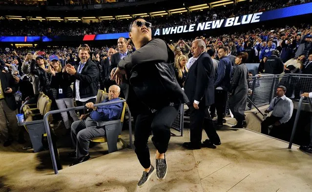 Korean pop star PSY dances for fans as the Los Angeles Dodgers play the Colorado Rockies in Los Angeles, on April 30, 2013. (Photo by Mark J. Terrill/Associated Press)