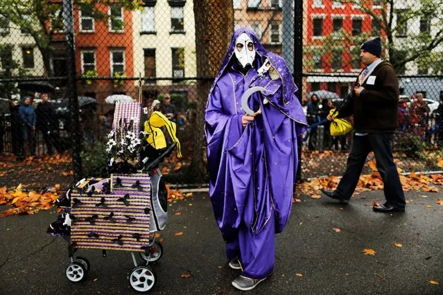 A reveller takes part in the annual halloween dog parade at Manhattan's Tompkins Square Park in New York, U.S. October 22, 2016. (Photo by Eduardo Munoz/Reuters)