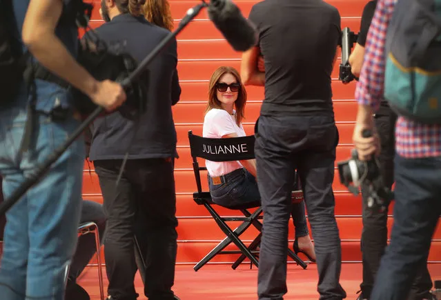 US actress Julianne Moore adjusts her sunglasses as she takes part in the shooting of a promotional event on the red carpet outside the festival' s palace, on May 8, 2018 ahead of the opening ceremony of the 71 st edition of the Cannes Film Festival in Cannes, southern France. (Photo by Valery Hache/AFP Photo)
