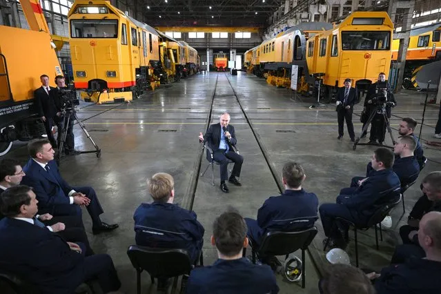Russian President Vladimir Putin meets with workers as he visits the Tulazheldormash plant, Russian leading machine-building enterprise, in Tula on April 4, 2023. (Photo by Ramil Sitdikov/Sputnik via AFP Photo)
