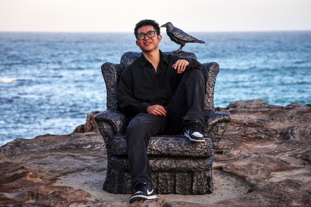 A member of the public sits in a work titled “For Peace” by Iraqi artist Ayad Alqaragholli that is part of the annual Sculpture by the Sea exhibition located near Bondi Beach in Sydney on October 16, 2025. The 27th Sculpture by the Sea exhibition is promoted as the world's largest annual, free-to-the-public, outdoor sculpture exhibition, with more than 100 sculptures by Australian and international artists. It runs from October 17 to November 3. (Photo by David Gray/AFP Photo)