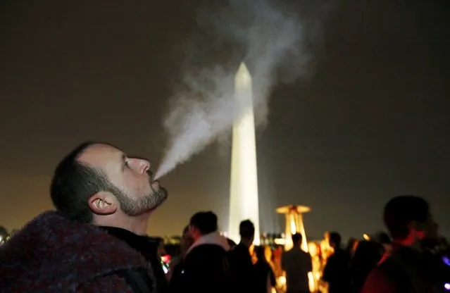 Participant Ian Kreer exhales from an e-cigarette in front of the Washington Monument during a 48-hour vigil called "Catharsis on the Mall: A Vigil for Healing the Drug War" on the U.S. National Mall in Washington November 21, 2015. (Photo by Jim Bourg/Reuters)