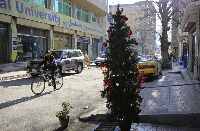 A Christmas tree is on display on a street in the Shar-e-Naw neighborhood of Kabul, Afghanistan, Thursday, December 24, 2020. (Photo by Mariam Zuhaib/AP Photo)