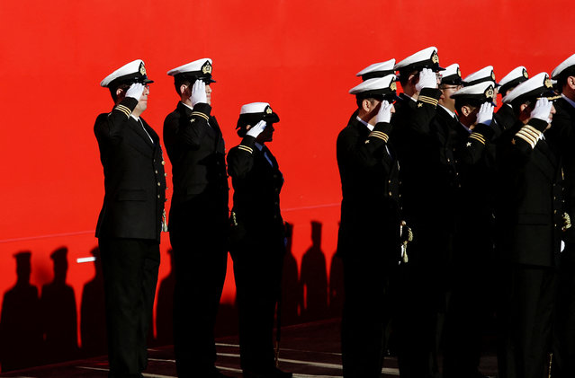 Members of the armed forces salute during the handover ceremony of the Chilean Navy's icebreaker “Almirante Viel”, the largest one built in Chile according to the Navy, in Talcahuano, Chile on July 3, 2024. (Photo by Juan Gonzalez/Reuters)