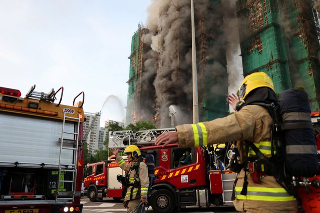 Firefighters work as efforts are underway to extinguish flames engulfing bamboo scaffolding across multiple buildings at the Wang Fuk Court housing estate in Tai Po, Hong Kong, China, on November 26, 2025. (Photo by Tyrone Siu/Reuters)