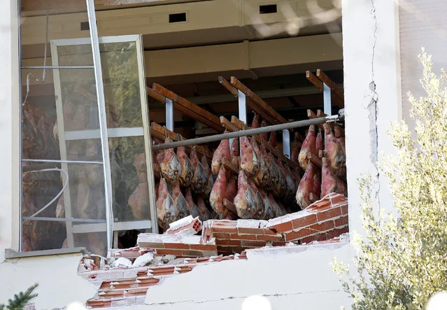 Hams are seen in a collapsed factory following an earthquake in Norcia, Italy, October 31, 2016. The third powerful earthquake to hit Italy in two months spared human life Sunday but struck at the nation's identity, destroying a Benedictine cathedral, a medieval tower and other beloved landmarks that had survived the earlier jolts across a mountainous region of small historic towns. (Photo by Remo Casilli/Reuters)