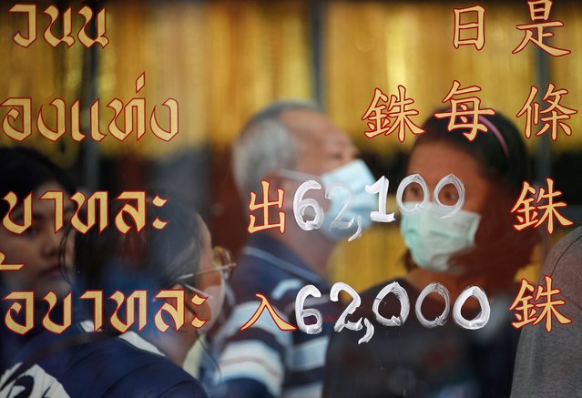 Customers trade gold behind a window displaying gold prices at the Hua Seng Heng gold shop in Bangkok, Thailand, 09 October 2025. Thailand’s gold prices continue to surge, following global trends as the spot price of gold surpassed 4,000 USD per ounce for the first time, with investors turning to the precious metal amid global political and economic uncertainty. (Photo by Rungroj Yongrit/EPA)