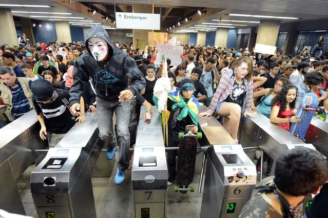 Students invade a subway station during a protest calling for a public transport free pass in the Federal District in Brasilia, on June 20, 2013. (Photo by Evaristo SA/AFP Photo)