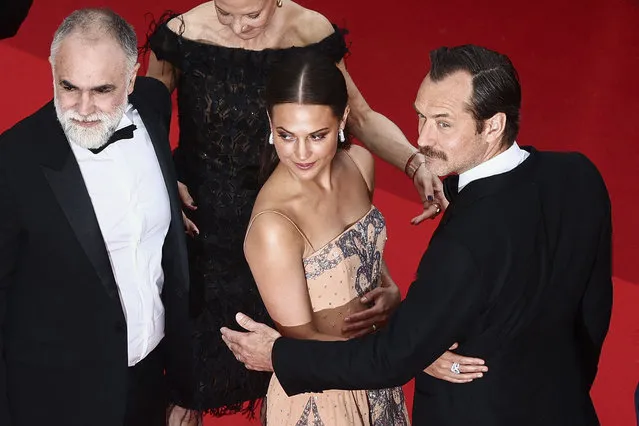 British actor Jude Law (R) pose with Swedish actress Alicia Vikander (C) and Brazilian film director Karim Ainouz for the screening of the film “Firebrand” during the 76th edition of the Cannes Film Festival in Cannes, southern France, on May 21, 2023. (Photo by Yara Nardi/Reuters)