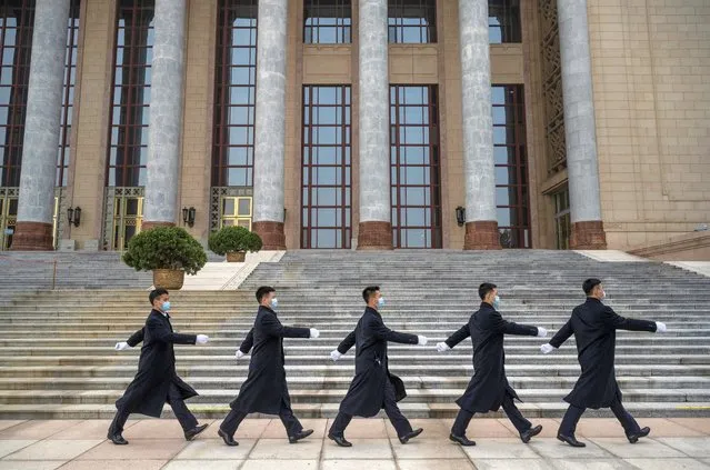 Chinese security wear protective masks as they march after the opening session of the Chinese People's Political Consultative Conference at the Great Hall of the People on March 4, 2021 in Beijing, China. The annual political gatherings of the National Peoples Congress and the Chinese People's Political Consultative Conference, known as the Two Sessions, brings together Chinas leadership and lawmakers to set the blueprint for the coming year.  It is considered the most important event on the governments calendar and offers a rare glimpse at what President Xi Jinping and top officials see as priorities.  With the pandemic largely under control in China, discussions this year are expected to signal Beijings intentions around technology competition, control over Hong Kong, and strategic threats posed by Western countries including the United States. The political meetings, held at the Great Hall of the People at the edge of Tiananmen Square in central Beijing, can typically last for up to two weeks. (Photo by Kevin Frayer/Getty Images)