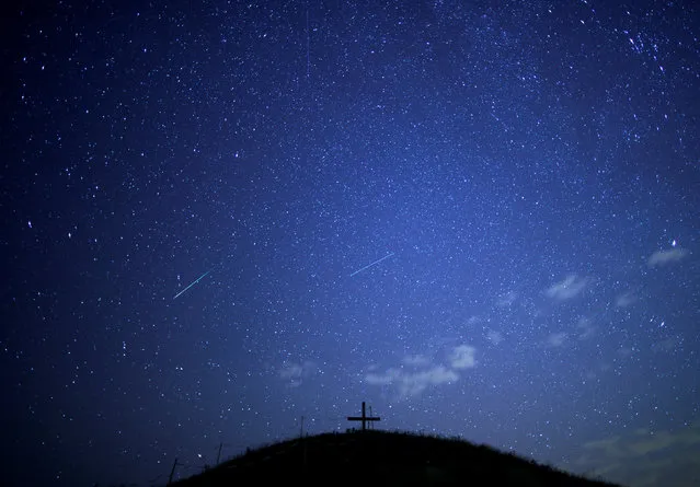 A meteor streaks past stars in the night sky above Leeberg hill during the Perseid meteor shower in Grossmugl, Austria, August 10, 2018. (Photo by Heinz-Peter Bader/Reuters)