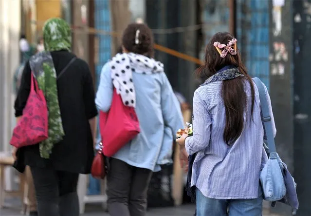 Iranian women walk on a street during the revival of morality police in Tehran, Iran on July 16, 2023. (Photo by Majid Asgaripour/WANA (West Asia News Agency) via Reuters)