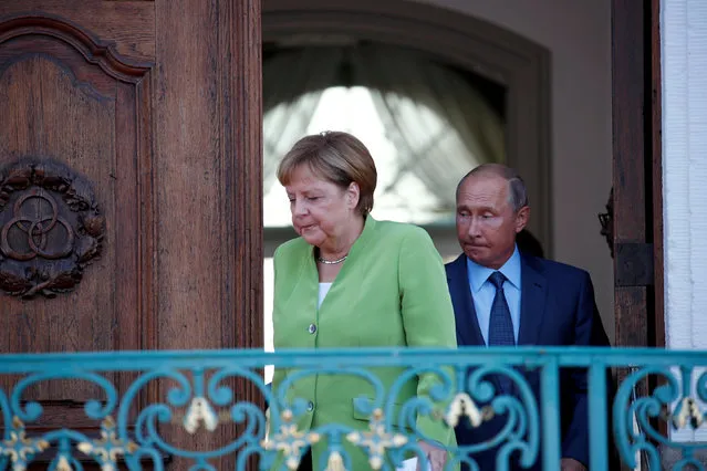 German Chancellor Angela Merkel and Russian President Vladimir Putin arrive to address the media before a meeting at the German government guest house Meseberg Palace in Gransee, Germany on August 18, 2018. (Photo by Axel Schmidt/Reuters)