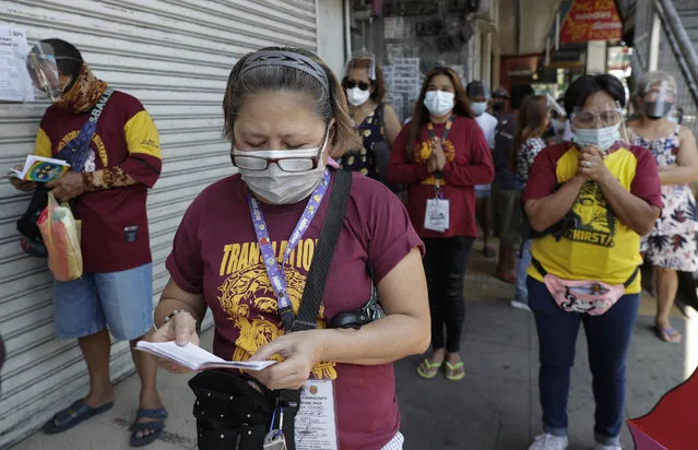Devotees offers prayers outside the Quiapo Church on Good Friday, April 2, 2021 as the government implements a strict lockdown to prevent the spread of the coronavirus in Manila, Philippines. (Photo by Aaron Favila/AP Photo)