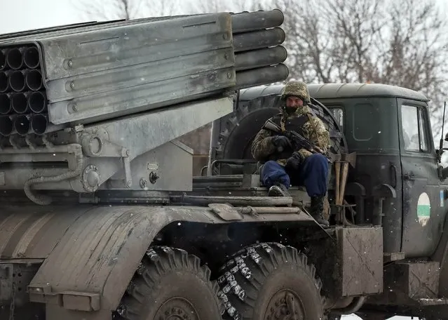 A member of the Ukrainian armed forces ride on a Grad multiple rocket launcher system near Debaltseve, eastern Ukraine February 16, 2015. (Photo by Gleb Garanich/Reuters)