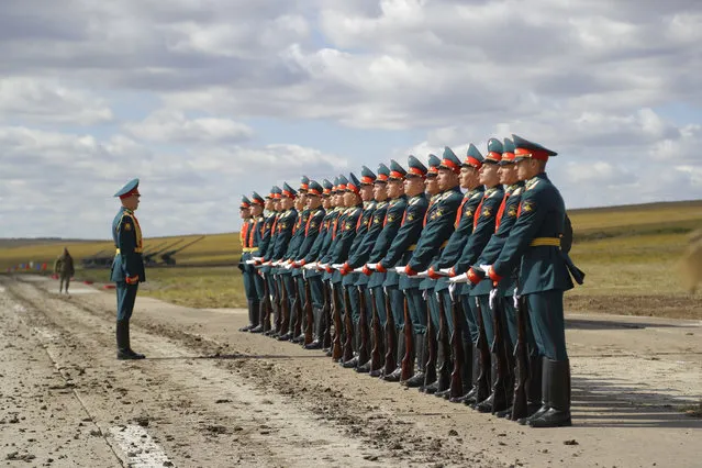 Russian honors guard prepares to take a part in a parade prior to a military exercises on training ground “Tsugol”, about 250 kilometers (156 miles ) south-east of the city of Chita during Vostok 2018 in Eastern Siberia, Russia, Thursday, September 13, 2018. (Photo by Sergei Grits/AP Photo)