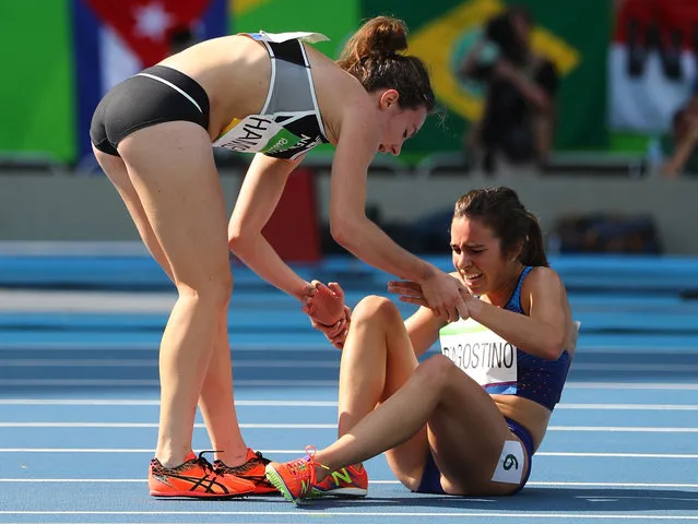 Nikki Hamblin of New Zealand stops running during the race to help fellow competitor Abbey D'Agostino of the USA after D'Agostino suffered a cramp in the 5,000m heats at the Rio Olympics August 16, 2016. (Photo by Kai Pfaffenbach/Reuters)