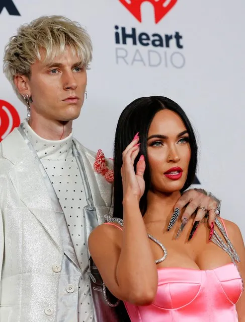 Machine Gun Kelly, accompanied by Megan Fox, poses with his award for Alternative Rock Album of the Year at the 2021 iHeartRadio Music Awards at Dolby Theatre in Los Angeles, California, U.S., May 27, 2021. (Photo by Mario Anzuoni/Reuters)