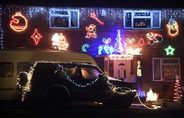 A home is decorated with a display of  Christmas of lights in a tradition that has grown over recent years in the small village of Westfield in Sussex, south east England, December 15, 2016. (Photo by Toby Melville/Reuters)