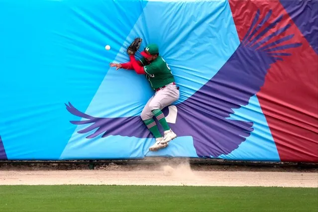 Mexico's left fielder Norberto Obeso fails to catch a double hit during the baseball bronze medal match against Panama's at the Pan American Games in Santiago, Chile, Saturday, October 28, 2023. (Photo by Moises Castillo/AP Photo)
