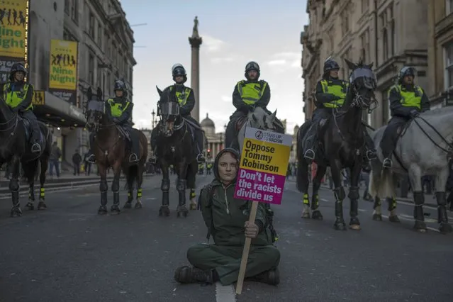 A woman sits in front of a line of Police Horses during a UKIP-backed Brexit betrayal rally in central London on December 9, 2018 in London, England. The demonstration takes place three days before parliament is due to make the crucial vote on Theresa May's Brexit deal with the European Union. (Photo by Dan Kitwood/Getty Images)