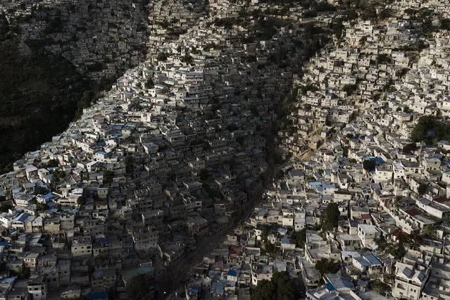 Homes stand densely packed in the Jalouise neighborhood of Port-au-Prince, Haiti, early Tuesday, July 13, 2021. (Photo by Matias Delacroix/AP Photo)