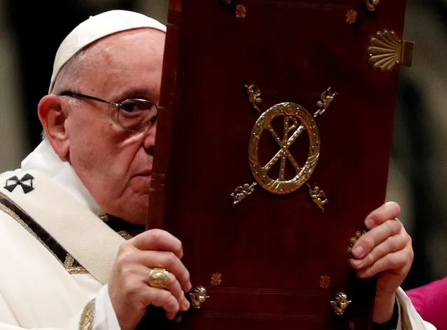 Pope Francis holds the Book of the Gospels as he leads the Christmas Eve mass in Saint Peter's Basilica at the Vatican, December 24, 2018. (Photo by Max Rossi/Reuters)