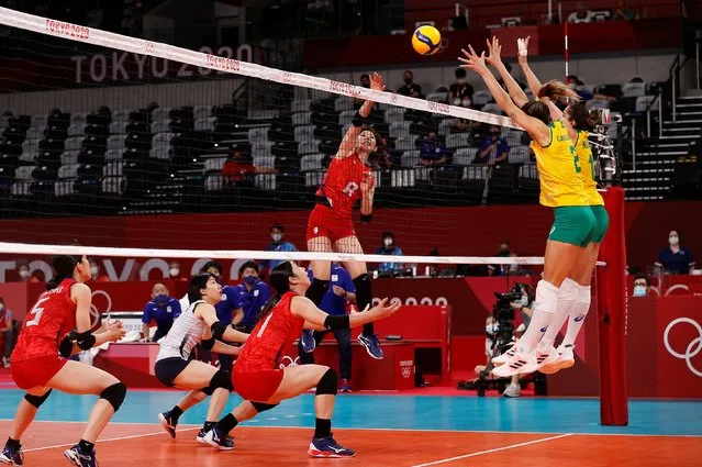 Yuki Ishii of Japan in action with Carol Gattaz of Brazil during Women's Pool A Volleyball at Ariake Arena in Tokyo, Japan on July 29, 2021. (Photo by Valentyn Ogirenko/Reuters)