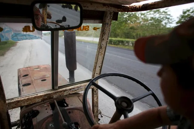 Sara Carcache, 40, drives her 1970 Ukrainian made tractor in Caimito, Cuba, February 15, 2016. The U.S. government has granted an Alabama company permission to build tractors in Cuba, one of the company's co-owners said on Monday, making it potentially the first American manufacturer to open shop in Cuba since the 1959 revolution. (Photo by Alexandre Meneghini/Reuters)