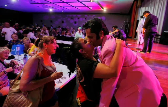 Elvis Presley tribute artist Stuart Vieyra receives a kiss from a member of the audience after making the final 8 contestants in a singing competition at the 25th annual Parkes Elvis Festival in the rural Australian town of Parkes, west of Sydney, Australia January 13, 2017. (Photo by Jason Reed/Reuters)