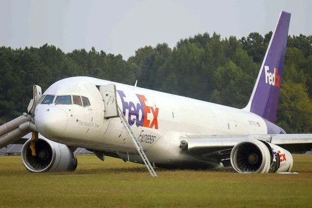 A FedEx 757 sits on a landing strip Thursday, October 5, 2023 at the Chattanooga Metropolitan Airport after crash landing late Wednesday evening.  Officials say the FedEx plane skidded off the runway during a crash landing when its landing gear did not descend, but no one was injured. (Photo by Olivia Ross/Chattanooga Times Free Press via AP Photo)