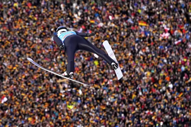 Andreas Wellinger, of Germany, soars through the air during his first round jump at the second stage of the 72th Four Hills ski jumping tournament in Garmisch-Partenkirchen, Germany, Monday, January 1, 2024. (Photo by Matthias Schrader/AP Photo)