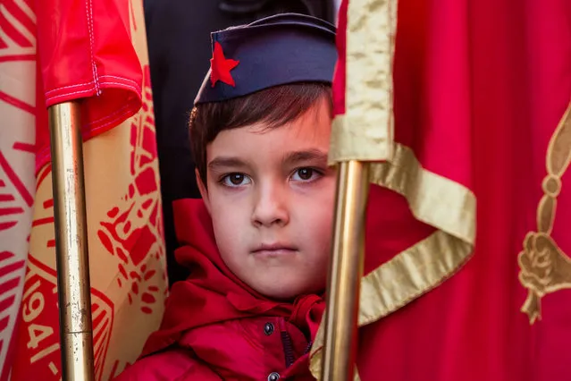 A boy wearing pioneer hat stand between flag poles during unveiling ceremony of the monument to the late Yugoslav leader Josip Broz Tito in Podgorica, Montenegro, December 19, 2018. (Photo by Stevo Vasiljevic/Reuters)