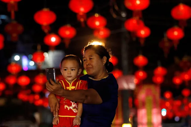A woman and a boy take a picture on a street decorated with Chinese lamps to celebrate the Lunar New Year in Yangon, Myanmar January 25, 2017. (Photo by Soe Zeya Tun/Reuters)