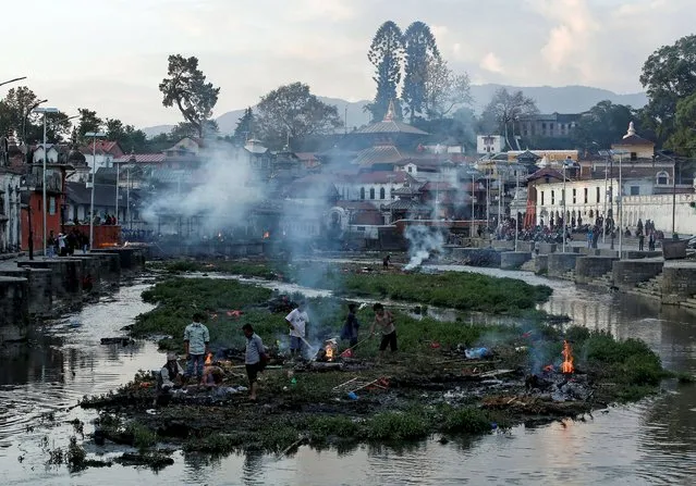 Victims of Saturday's earthquake are cremated along a river in Kathmandu, Nepal, April 27, 2015. (Photo by Danish Siddiqui/Reuters)
