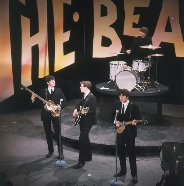 The Beatles, minus an ailing George Harrison, perform on the “Ed Sullivan Show”, February 8, 1964. In front, left to right: Paul McCartney, Neil Aspinall (standing in for Harrison), and John Lennon. On drums is Ringo Starr. (Photo by AP Photo)