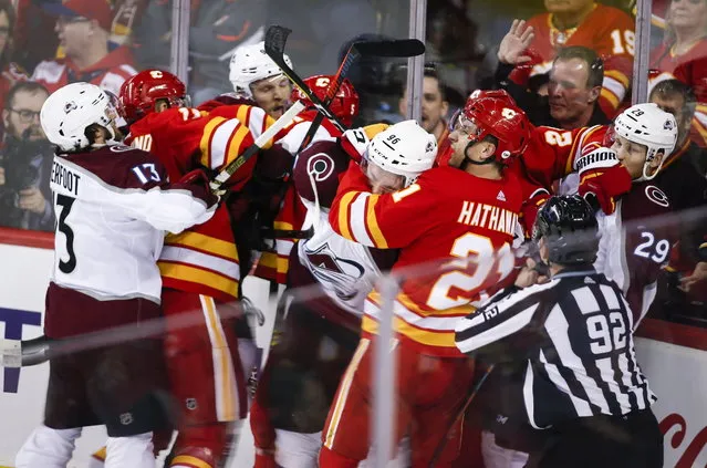 Colorado Avalanche and Calgary Flames players tussle during the first period of Game 2 of an NHL hockey first-round playoff series Saturday, April 13, 2019, in Calgary, Alberta. (Photo by Jeff McIntosh/The Canadian Press via AP Photo)