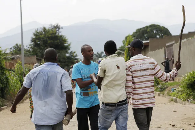 Demonstrators protesting against President Pierre Nkurunziza's decision to seek a third term in office confront a man in the Cibitoke district of Bujumbura, Burundi, Thursday May 7, 2015. (Photo by Jerome Delay/AP Photo)