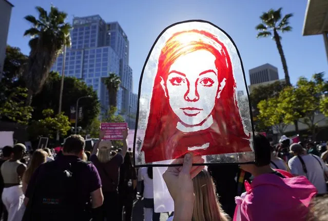 A Rubylith printing screen featuring a portrait of Britney Spears is held by Spears supporter Taylor Coppage outside a hearing concerning the pop singer's conservatorship at the Stanley Mosk Courthouse, Friday, November 12, 2021, in Los Angeles. A Los Angeles judge ended the conservatorship that has controlled Spears' life and money for nearly 14 years. (Photo by Chris Pizzello/AP Photo)